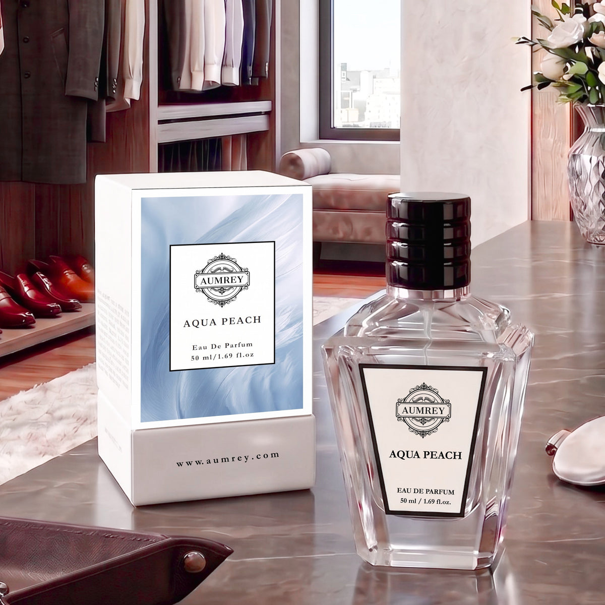 A bottle of Ambrey Aqua Peach Eau De Parfum next to its white and light blue packaging box, displayed on a polished wooden table in a luxury dressing room setting.