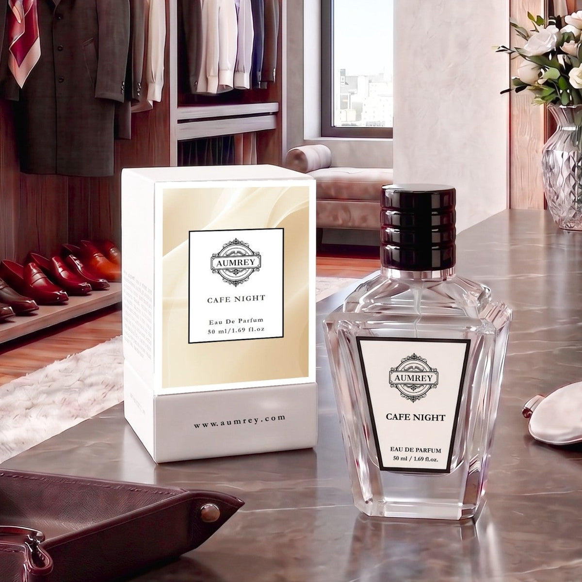 A bottle of Ambrey Cafe Night Eau De Parfum next to its white and beige packaging box, displayed on a dark wooden table in a luxurious, modern dressing room setting.