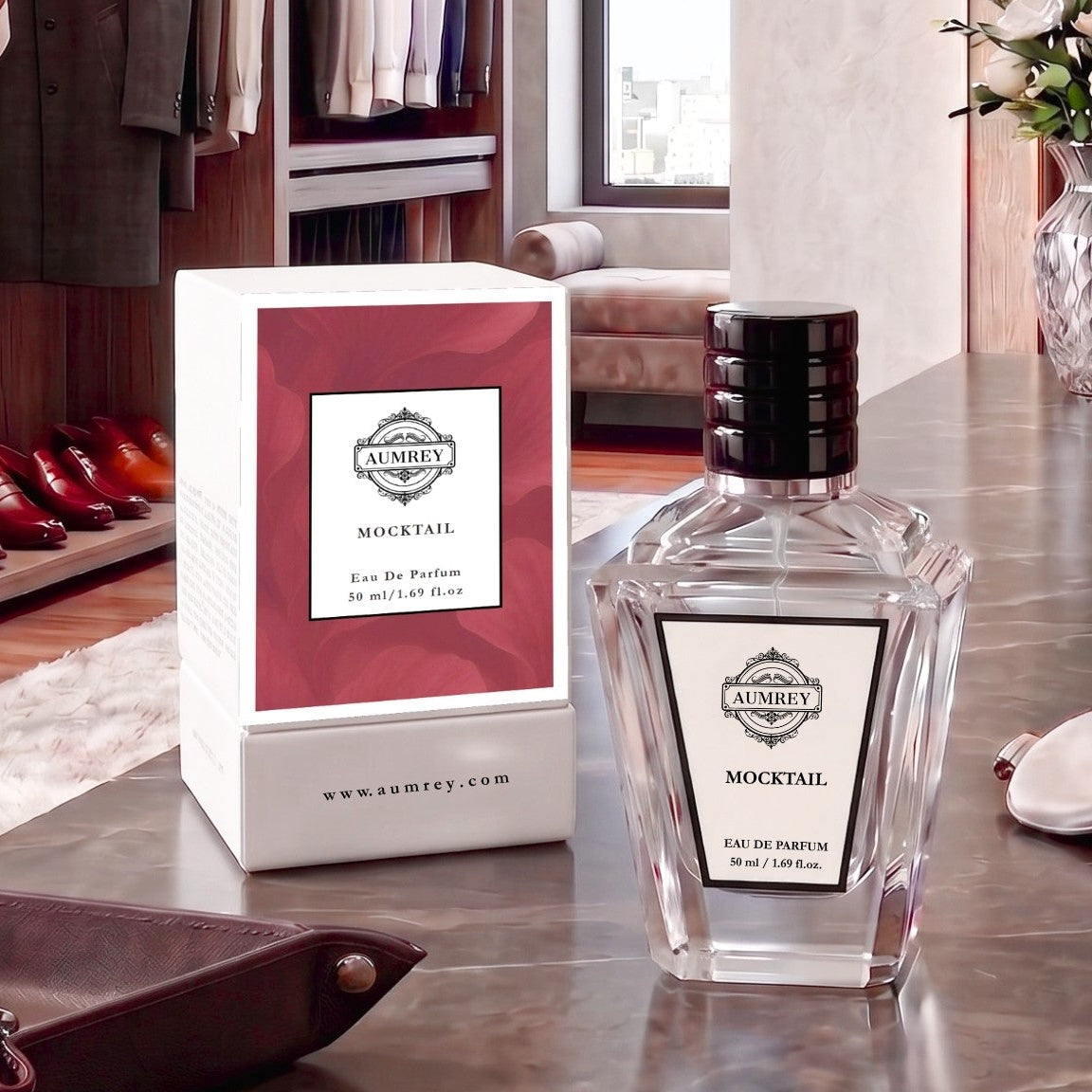 A bottle of Ambrey Mocktail Eau De Parfum next to its white and red packaging box, displayed on a polished marble countertop in a luxury dressing room setting.